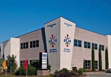 The Blue Moon Gift Shops exterior storefront at Racine Center in Wilmington, North Carolina.