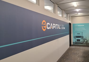 An interior wall with a wall graphic that says "e-capital "