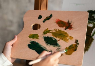 a woman is painting with a paintbrush and a brush