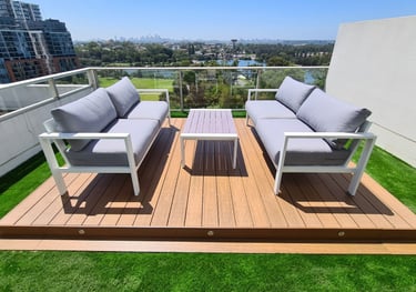Composite deck on a rooftop with an artificial grass surround
