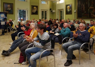 a group of people sitting in chairs in a room