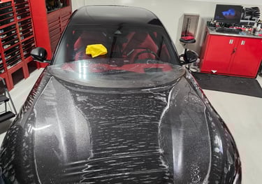 Overhead shot of an active Paint Protection Film (PPF) installation on a Ferrari Purosangue hood by 