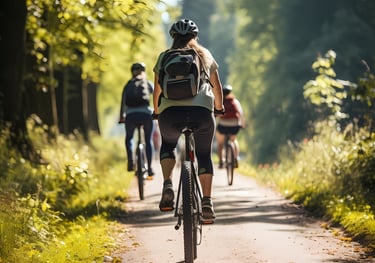 a group of people riding bikes down a path