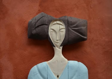 a woman's head and shoulders in wood