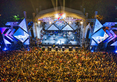 a large crowd of people standing around a stage