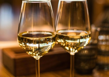 two wine glasses with wine glasses on a table