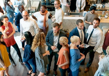 a group of people standing around a table