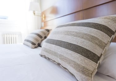 Picture of a hotel bed with close up to the pillows