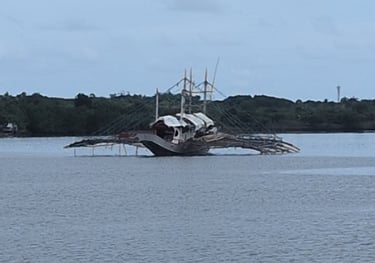 Anchored alongside a traditional boat of the Philippines