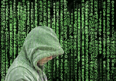 a man in a hoodie is looking at his phone