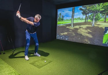 Luxury indoor golf simulator installation with impact screen and 4K projector in a London home.