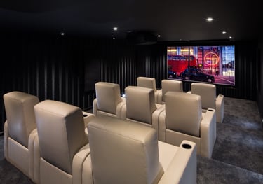 Bespoke home cinema installation with tiered seating and 4K projection in London.