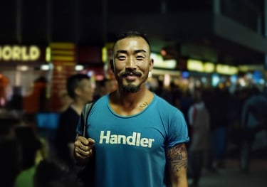Asian man in a green HANDLER t-shirt.