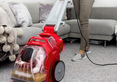 carpet rug cleaning a woman is cleaning a carpet with a vacuum