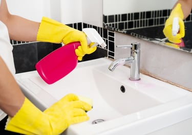 Domestic cleaning a person in yellow gloves cleaning a sink