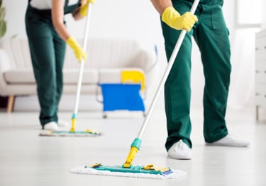 end of tenancy. a man and woman cleaning a floor with a mop