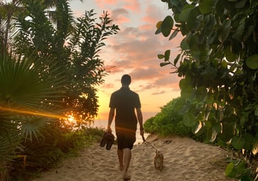 a man walking down a path with a dog