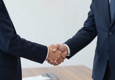 Two business professionals shaking hands in a minimalist meeting room, symbolizing successful negotiation. Palette includes #0F1E3D.