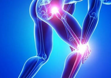 An orthopedic surgeon examining an X-ray of a patient’s knee joint in a clinical setting.