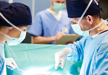 A surgical team performing an organ transplant procedure in a sterile operating theater.