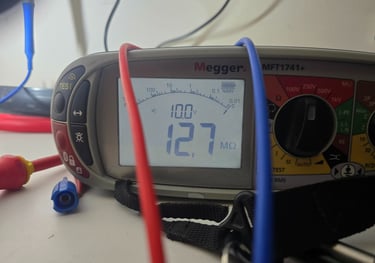 Megger electrical test instrument performing insulation resistance testing during an electrical inspection