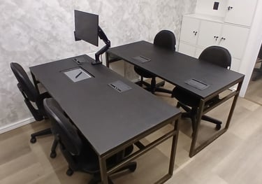 a desk with a computer monitor and a monitor