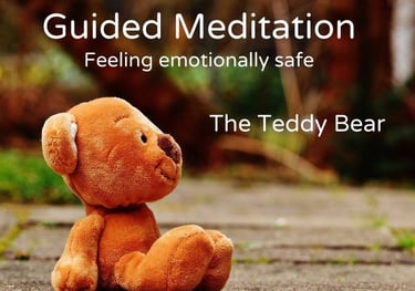 a teddy bear sitting on the ground