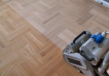 Belt sander is sanding wood floors. Sanding hardwood floors. Hardwood floor resurfacing.