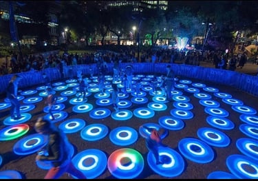 a group of people playing with frisbees in a circle