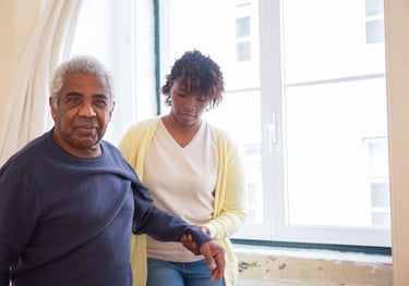 physiotherapy at home for seniors - an elderly man looking happy to be helped by The London Physio