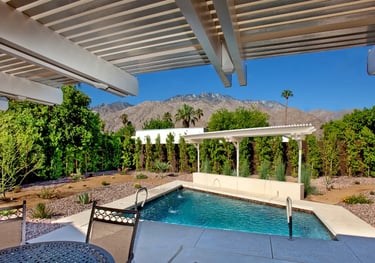 Patio cover with header above rafters with a veiw of pool.