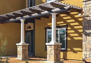 Spanish Brown Alumawood shade structure with decorative round columns on stone faced base.