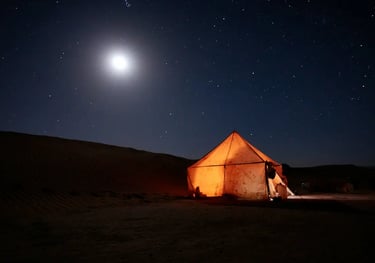 lluminated desert tent under full moon in the Sahara night sky