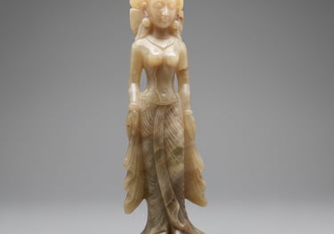 Elegant onyx stone sculpture of a serene female deity figure, semi-translucent with warm amber tones