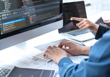 a man is typing on a computer screen