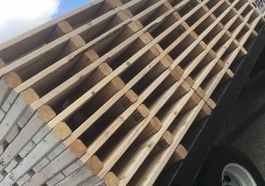 a truck with a large amount of wood pallets on it