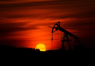 a large oil pump in the middle of a sunset