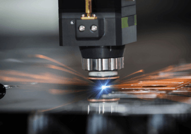 laser machine cutting through a piece of material
