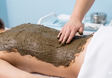 Therapist applying a natural Herbal Salve to the back to improve wellness.