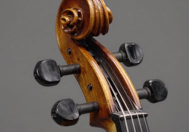 A high-detail close-up of a violin headstock and pegs, showing the exquisite dark walnut wood craftsmanship and elegant scrollwork.