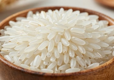 Close-up of high-quality long-grain white Jasmine rice grains in a polished wooden bowl, elegant natural lighting, clean and professional export-grade presentation.
