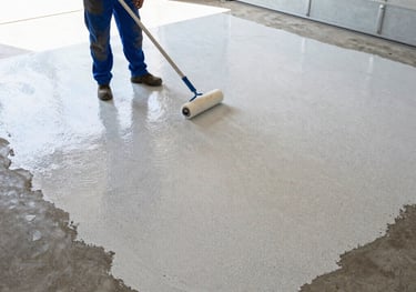 Contractor applying decorative flake epoxy coating to garage floor