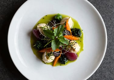 Top-down photography of a beautifully plated gourmet dish with fresh herbs and vibrant colors, shot in a professional North American / European studio setting with soft side lighting.