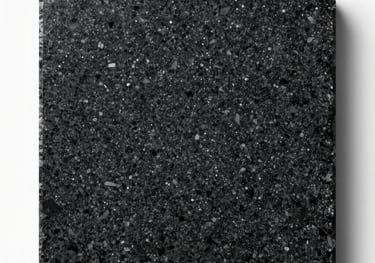A slab of deep black granite with silver speckles, photographed flat-lay with clean studio lighting to highlight its crystalline structure.