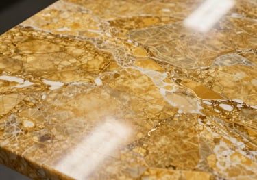 Close-up photography of a polished golden-hued marble slab, showing intricate natural patterns and a high-gloss reflective surface in a professional studio setting.