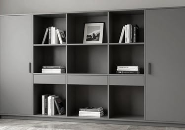 A high-end home office storage solution in a Miami residence, featuring sleek gray cabinetry and minimalist open shelving with luxury art books.
