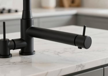 Close up of luxury black matte kitchen hardware and white marble countertop in a bright Miami kitchen, editorial photography style.