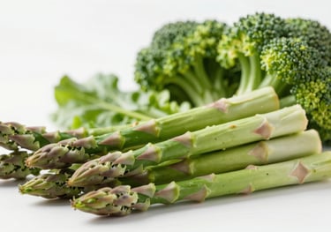 A clean, studio photograph of fresh green vegetables like asparagus and broccoli, arranged neatly. The lighting is bright and emphasizes the crispness and health of the produce.