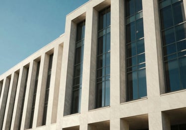 An architectural detail of a modern Australian civic building, showing clean geometric lines and blue glass under a clear sky.