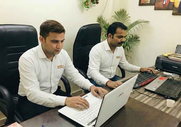 Professional security data operators from NSU India managing digital visitor records.